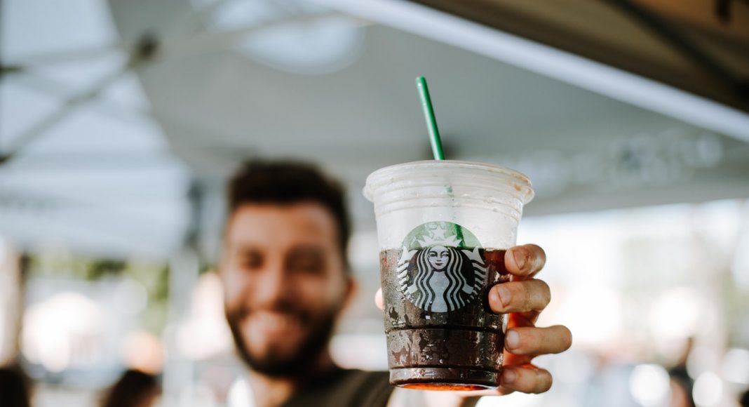 Man holding starbucks cup