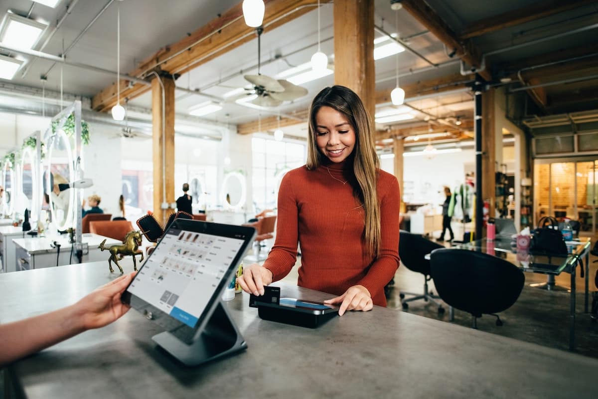 asian woman scanning debit card at a salon