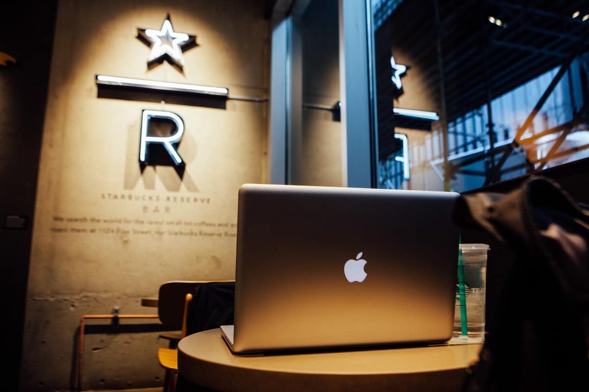 macbook on a table in a coffee shop